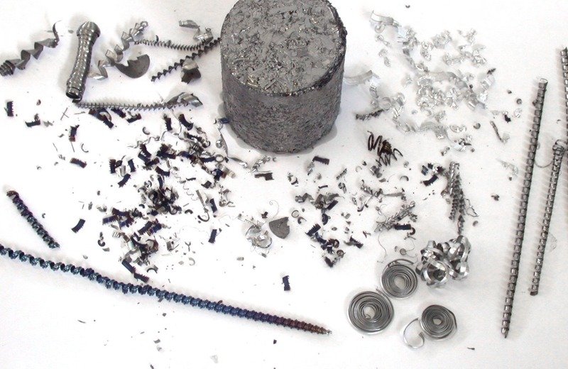 Industrial metal-bearing residues, machining swarf, turnings, and compressed briquette recovery